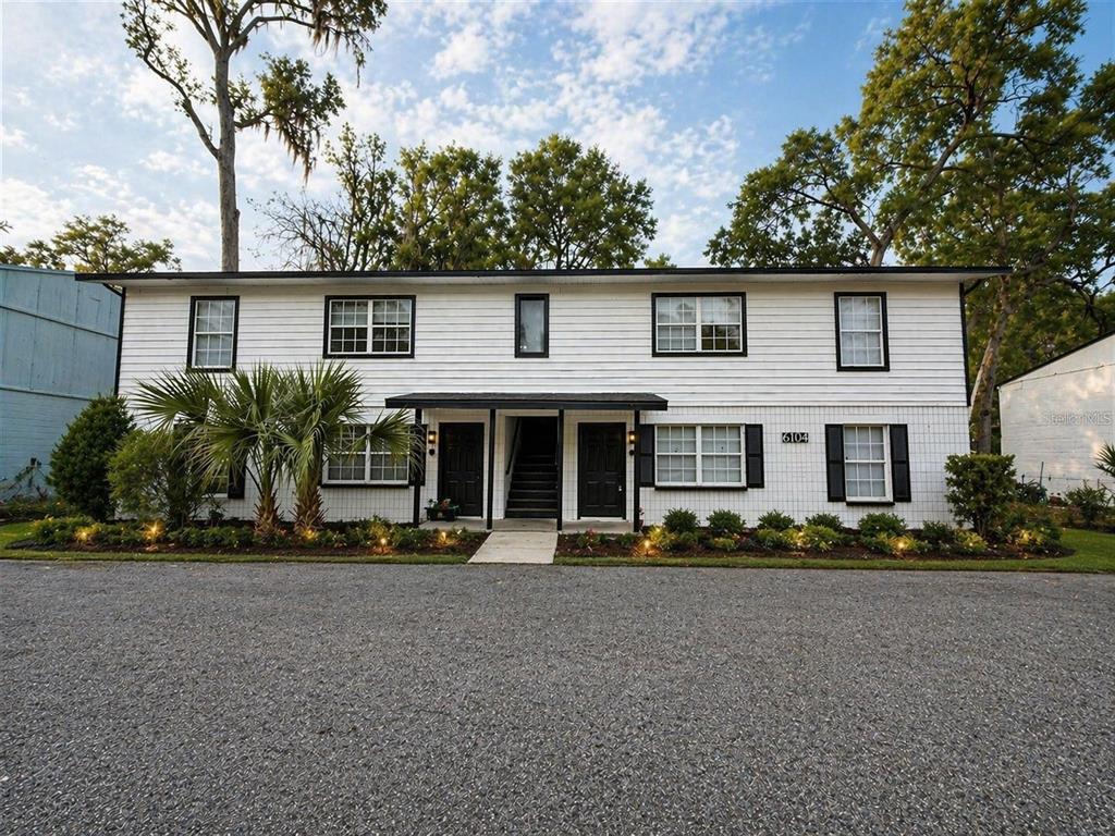 a front view of house with trees