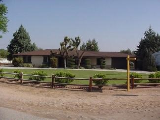 20408 Shawnee Road Apple Valley, CA 92308 - Photo 1 of 1 a front view of a house with a yard