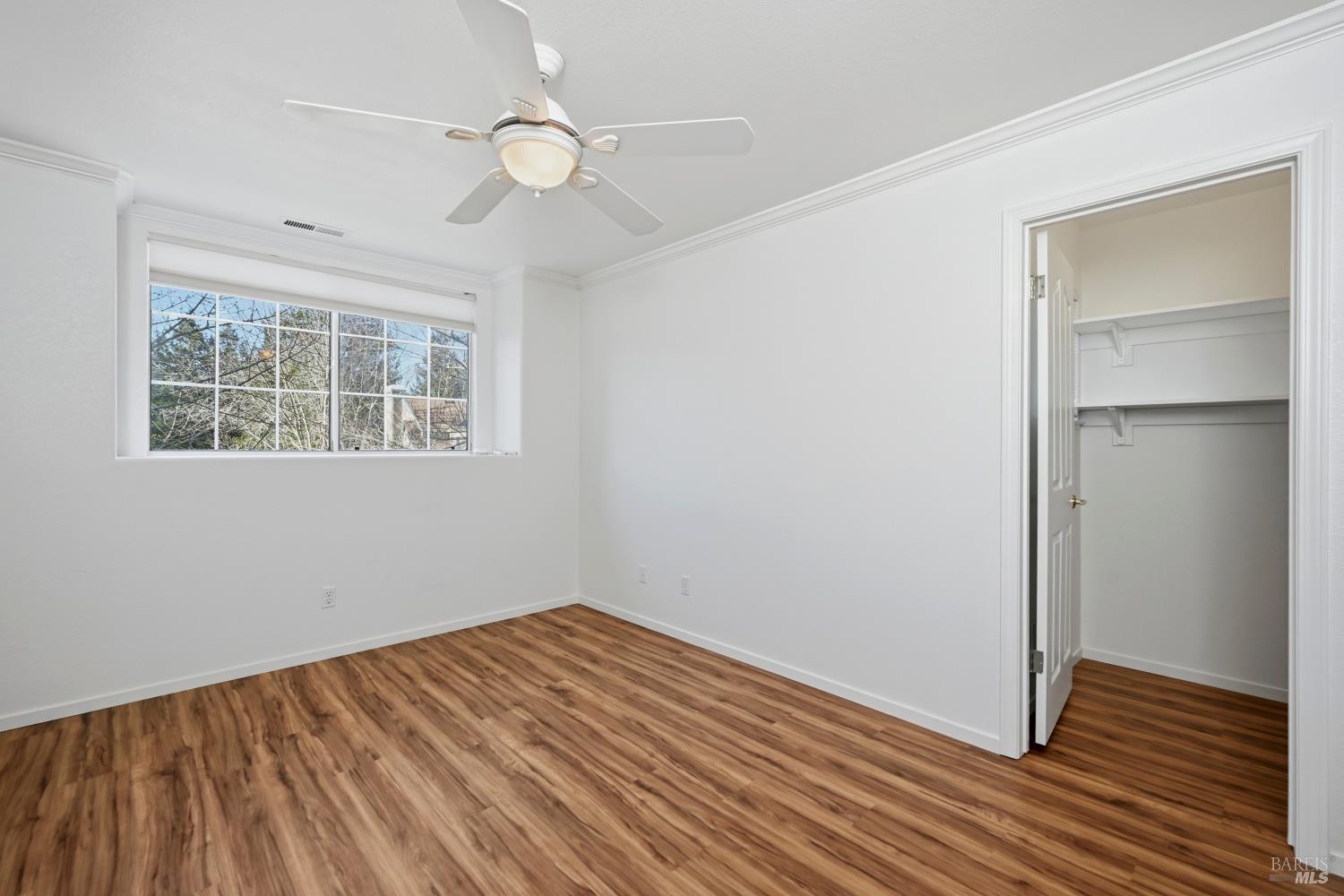 1005 Woodlake Drive Santa Rosa, CA 95405 - Photo 19 of 28 a view of empty room with wooden floor and fan