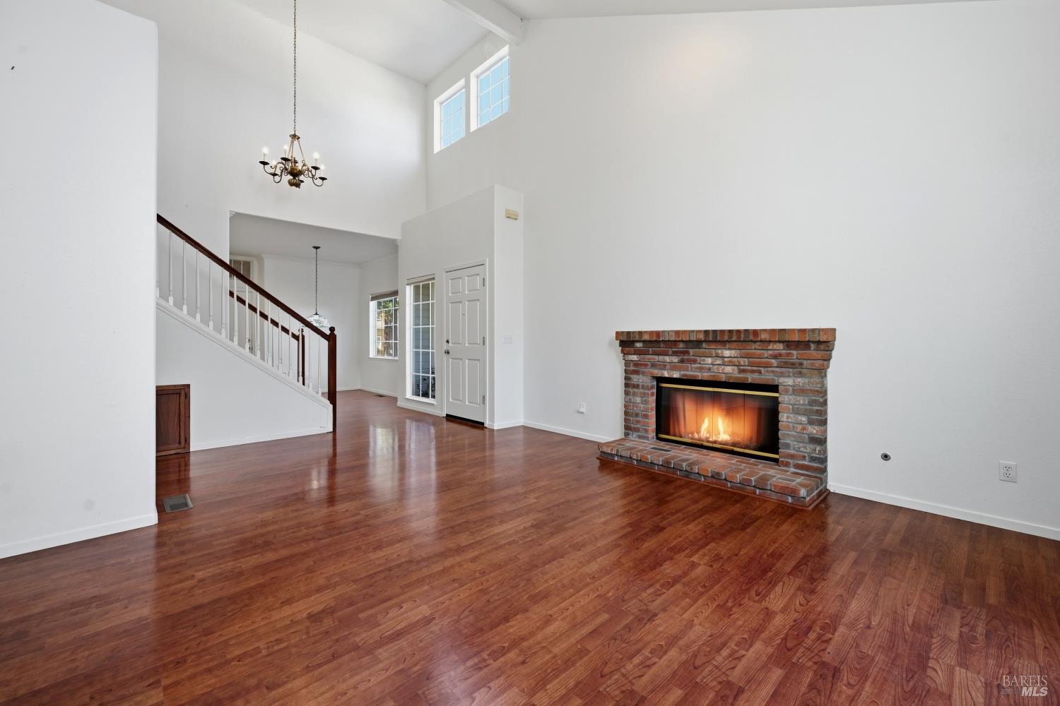 1005 Woodlake Drive Santa Rosa, CA 95405 - Photo 7 of 28 a view of an empty room with wooden floor and a fire place