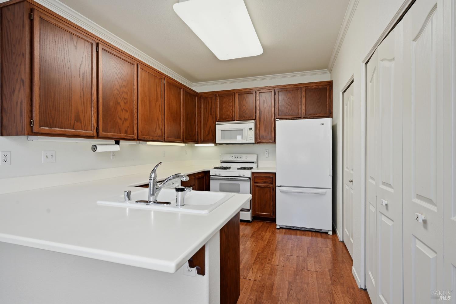 1005 Woodlake Drive Santa Rosa, CA 95405 - Photo 9 of 28 a kitchen with a sink a refrigerator and cabinets