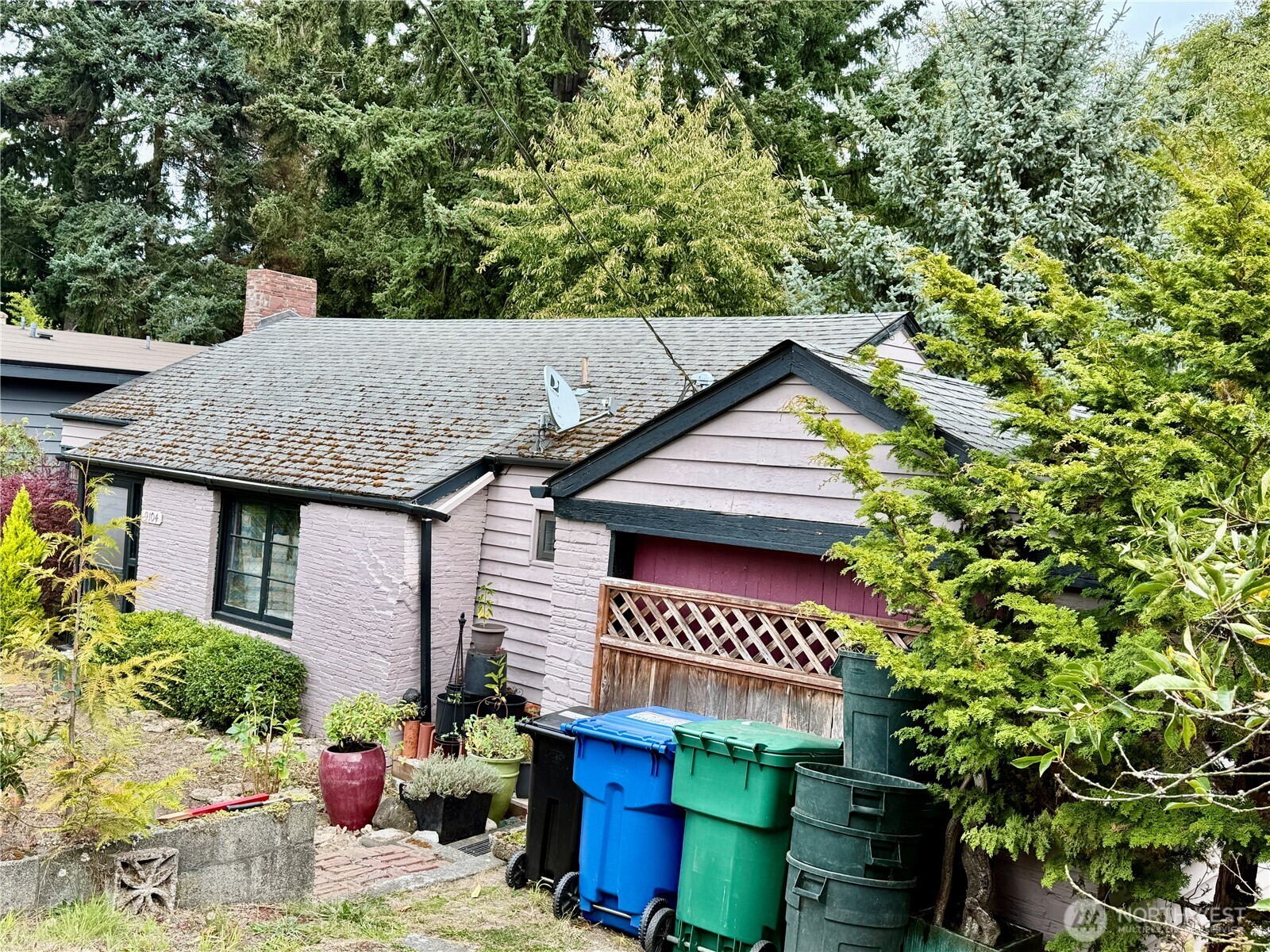 9104 28th Avenue Northwest Seattle, WA 98117 - Photo 2 of 5 a sign that is sitting in front of a house