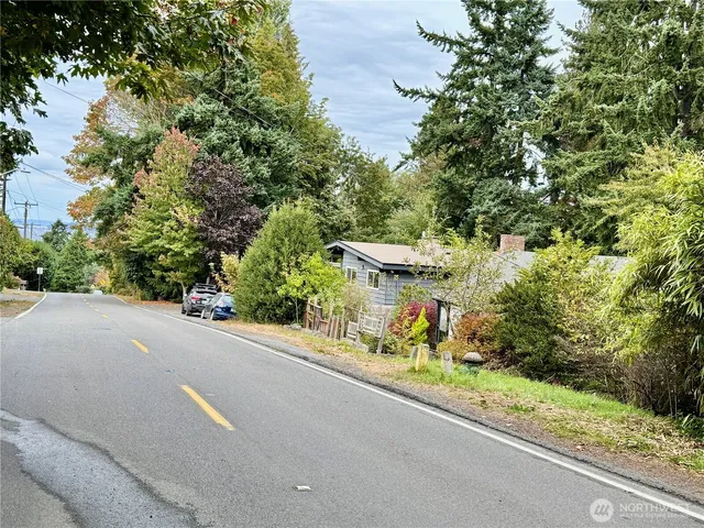 a view of a street with a couple of cars parked on road