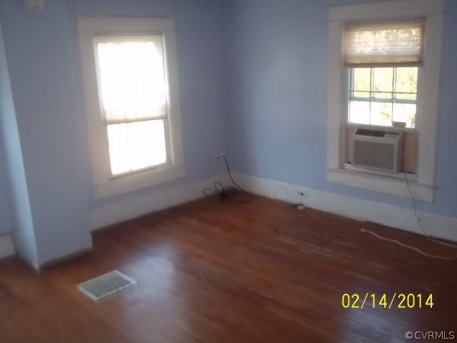 359 Sandy Road Diggs, VA 23045 - Photo 3 of 9 an empty room with wooden floor and windows