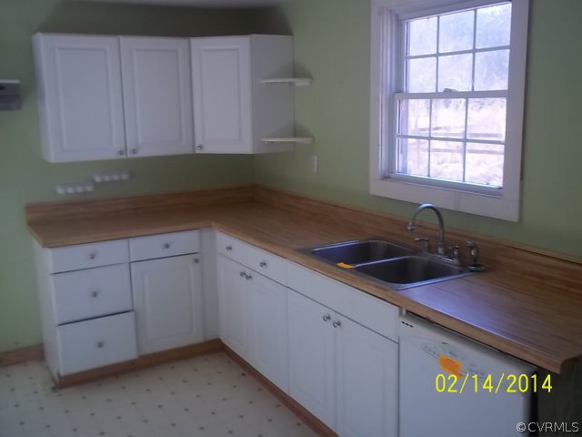 359 Sandy Road Diggs, VA 23045 - Photo 5 of 9 a kitchen with a sink cabinets and window