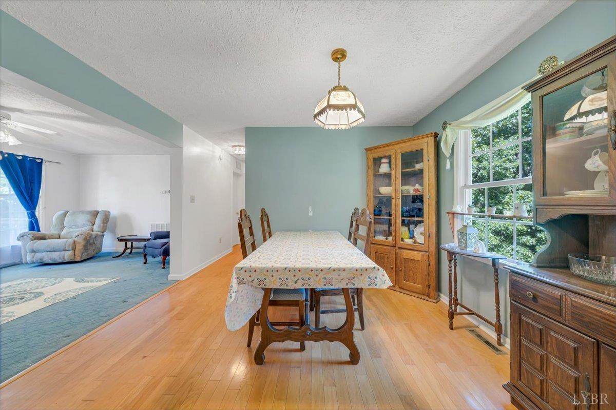 1124 Homeplace Road Bedford, VA 24523 - Photo 10 of 47 a view of a dining room with furniture window and wooden floor