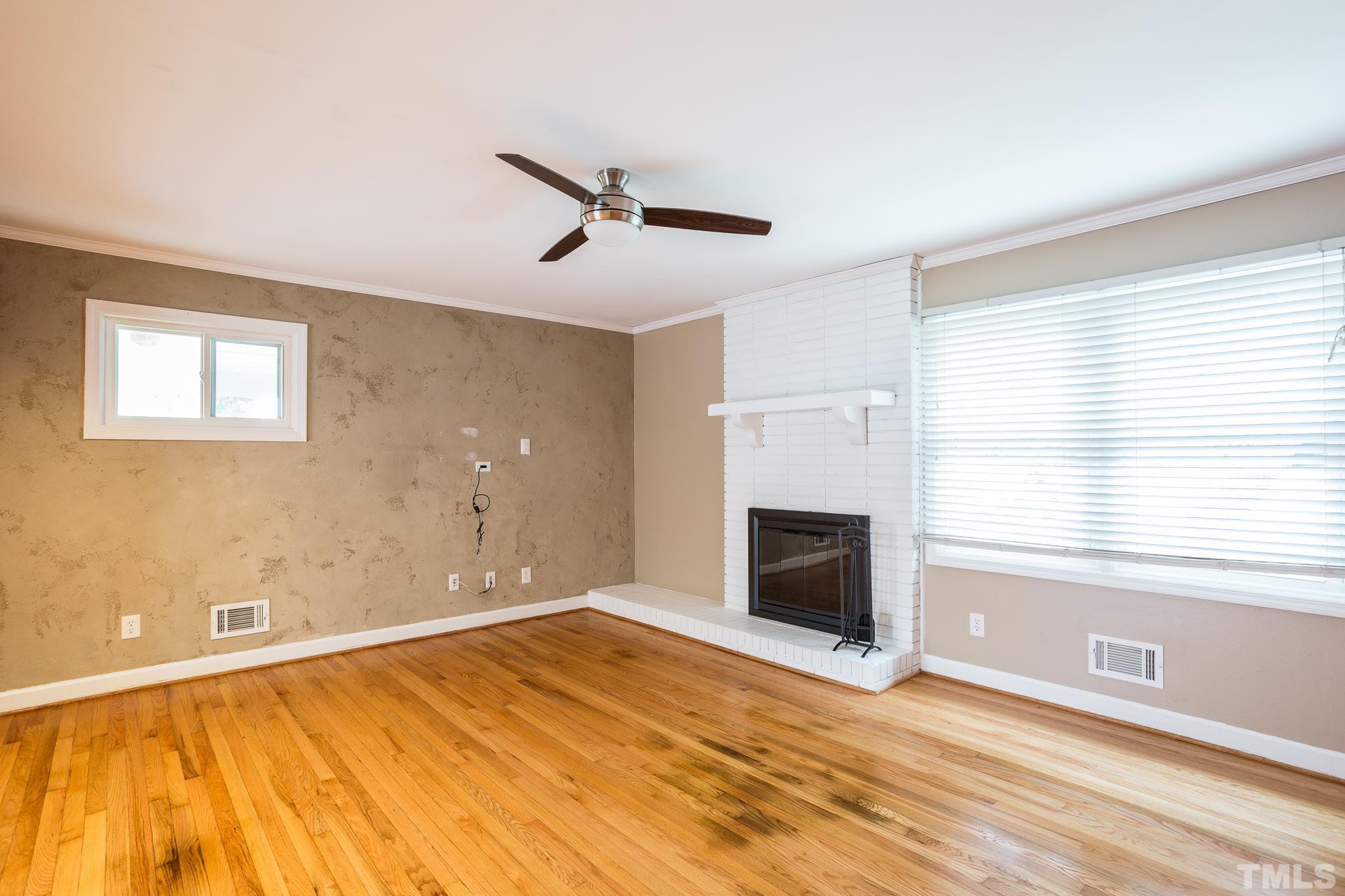 3620 Marsh Creek Road Raleigh, NC 27604 - Photo 11 of 25 a view of empty room with wooden floor and fireplace