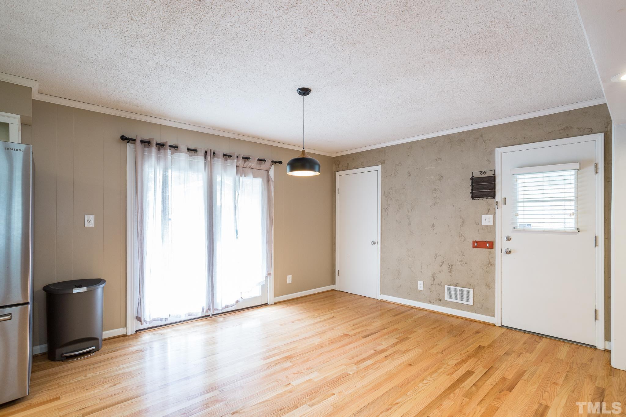 3620 Marsh Creek Road Raleigh, NC 27604 - Photo 12 of 25 a view of an empty room with wooden floor and a window