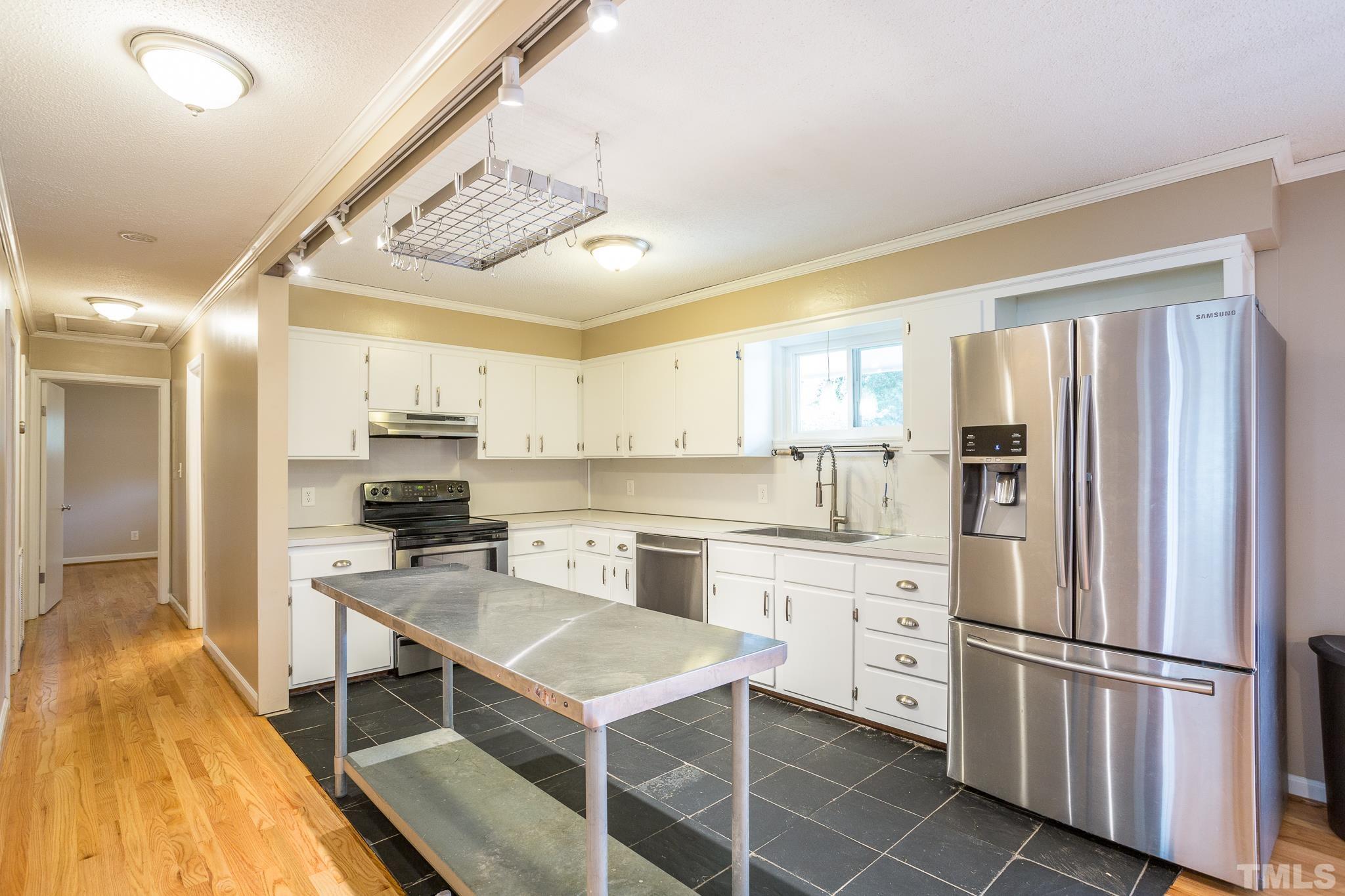 3620 Marsh Creek Road Raleigh, NC 27604 - Photo 5 of 25 a kitchen with stainless steel appliances a stove a sink and a refrigerator
