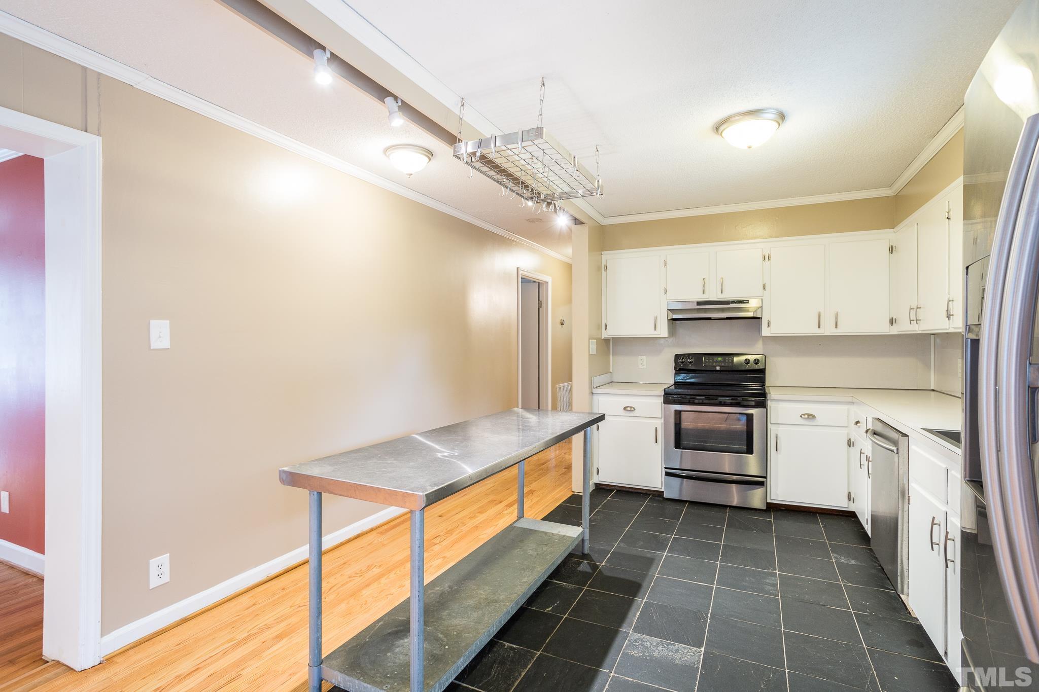 3620 Marsh Creek Road Raleigh, NC 27604 - Photo 6 of 25 a kitchen with stainless steel appliances a refrigerator sink and stove