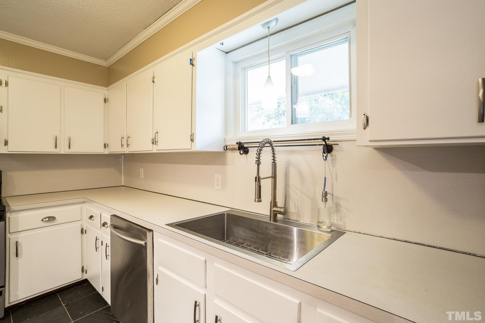 3620 Marsh Creek Road Raleigh, NC 27604 - Photo 7 of 25 a kitchen with a sink and cabinets