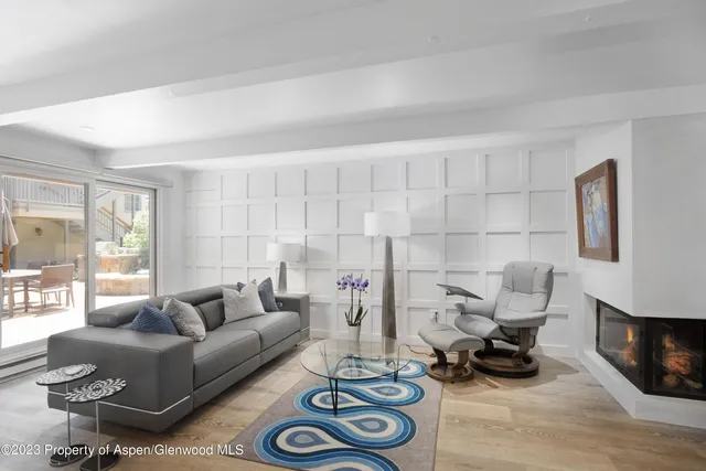 a living room with furniture a rug and a window