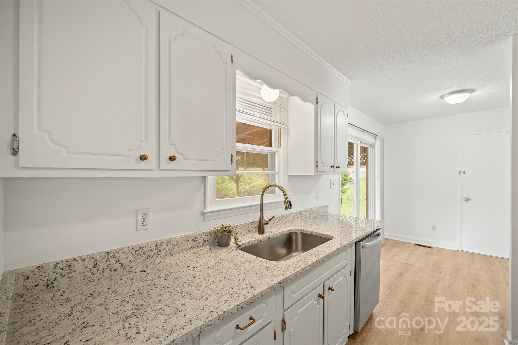 303 Windy Rush Road Kannapolis, NC 28081 - Photo 14 of 30 a kitchen with granite countertop white cabinets and sink