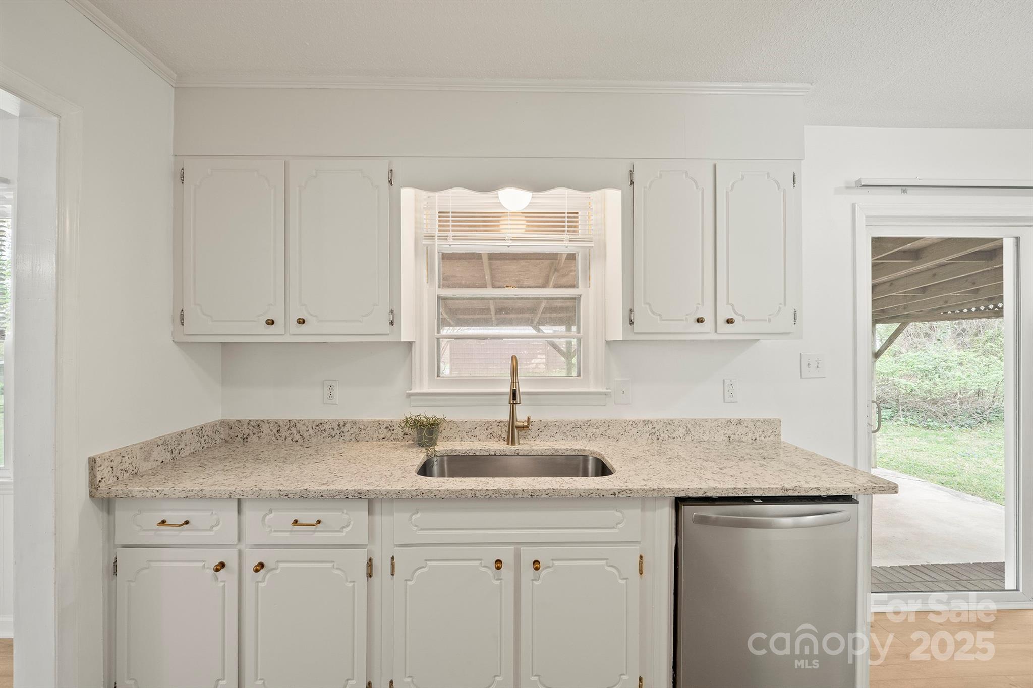303 Windy Rush Road Kannapolis, NC 28081 - Photo 15 of 30 a kitchen with granite countertop a sink stainless steel appliances white cabinets and a window