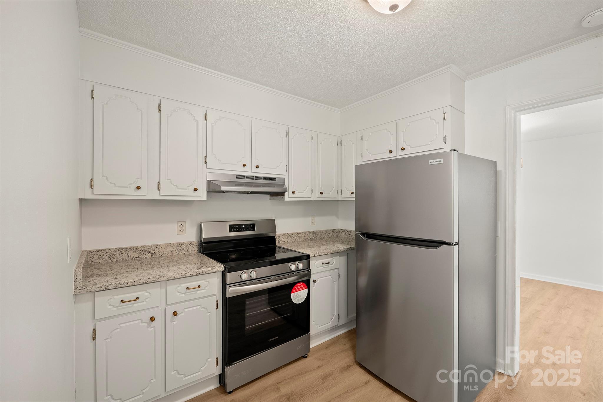 303 Windy Rush Road Kannapolis, NC 28081 - Photo 16 of 30 a kitchen with refrigerator a stove a sink and cabinets