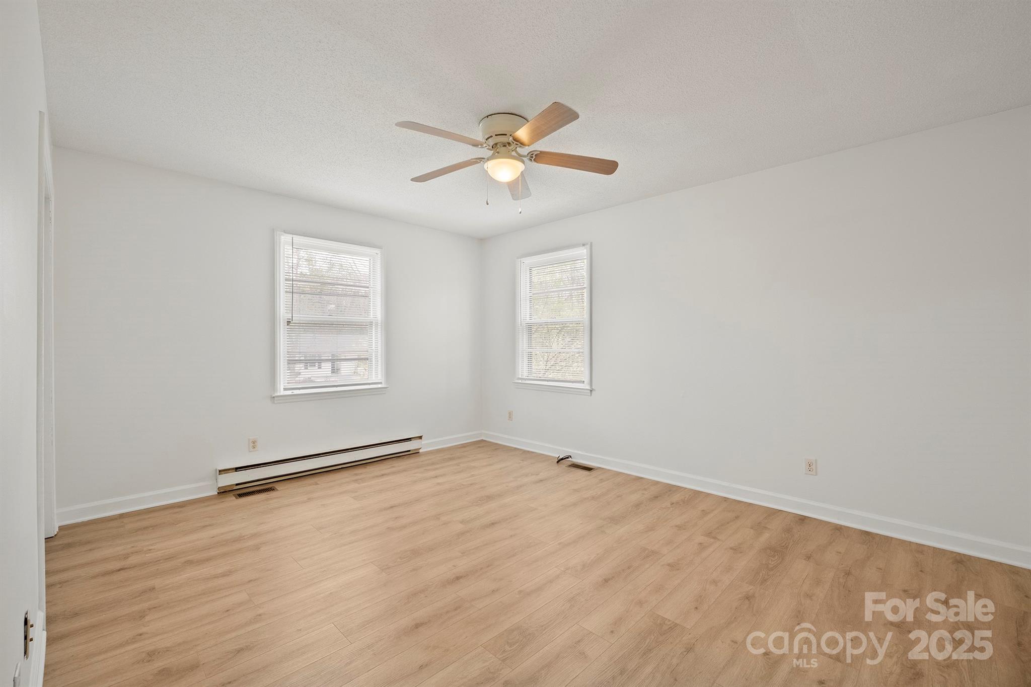 303 Windy Rush Road Kannapolis, NC 28081 - Photo 26 of 30 an empty room with windows and fan