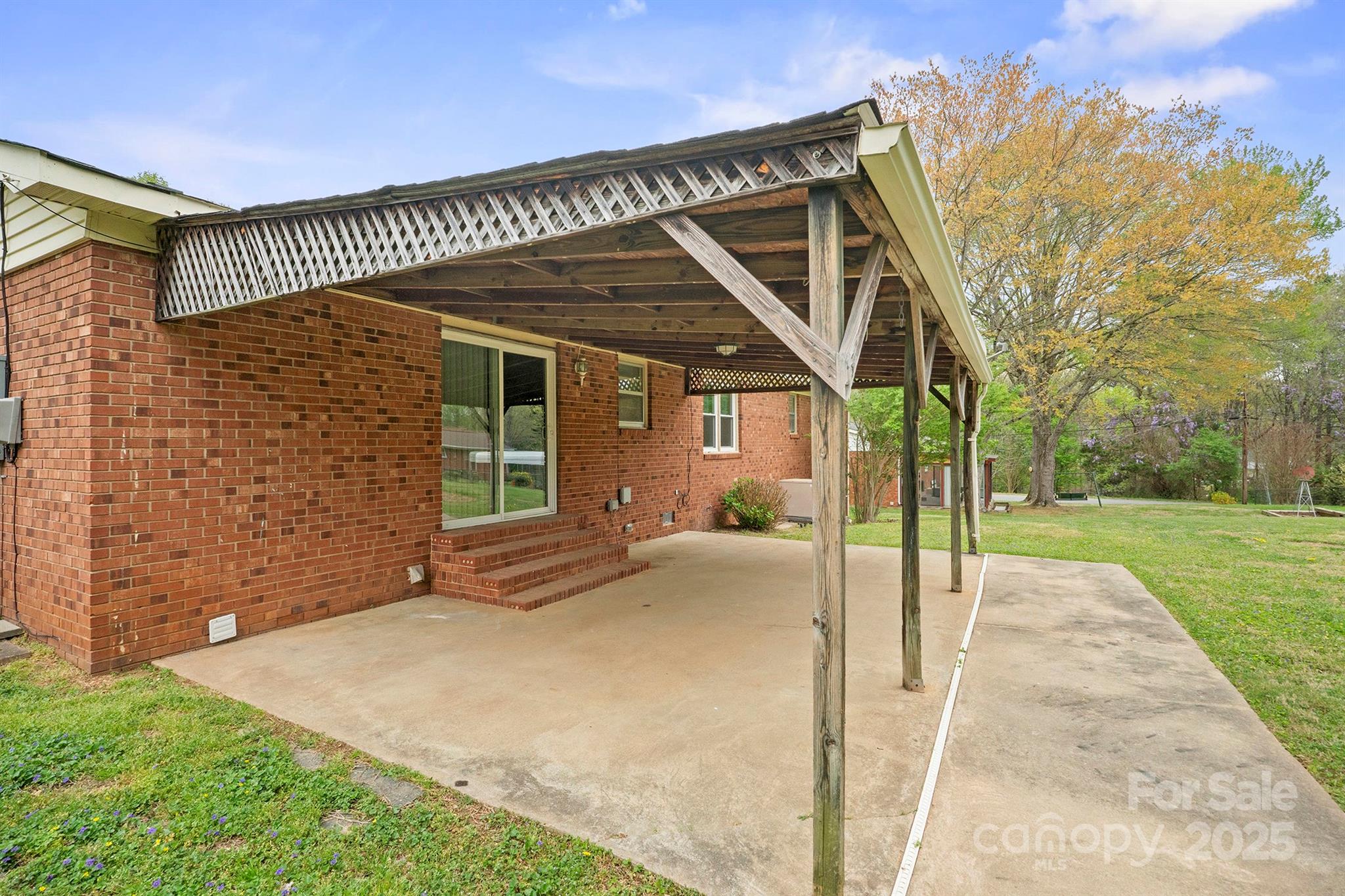 303 Windy Rush Road Kannapolis, NC 28081 - Photo 28 of 30 a porch with a table and chairs