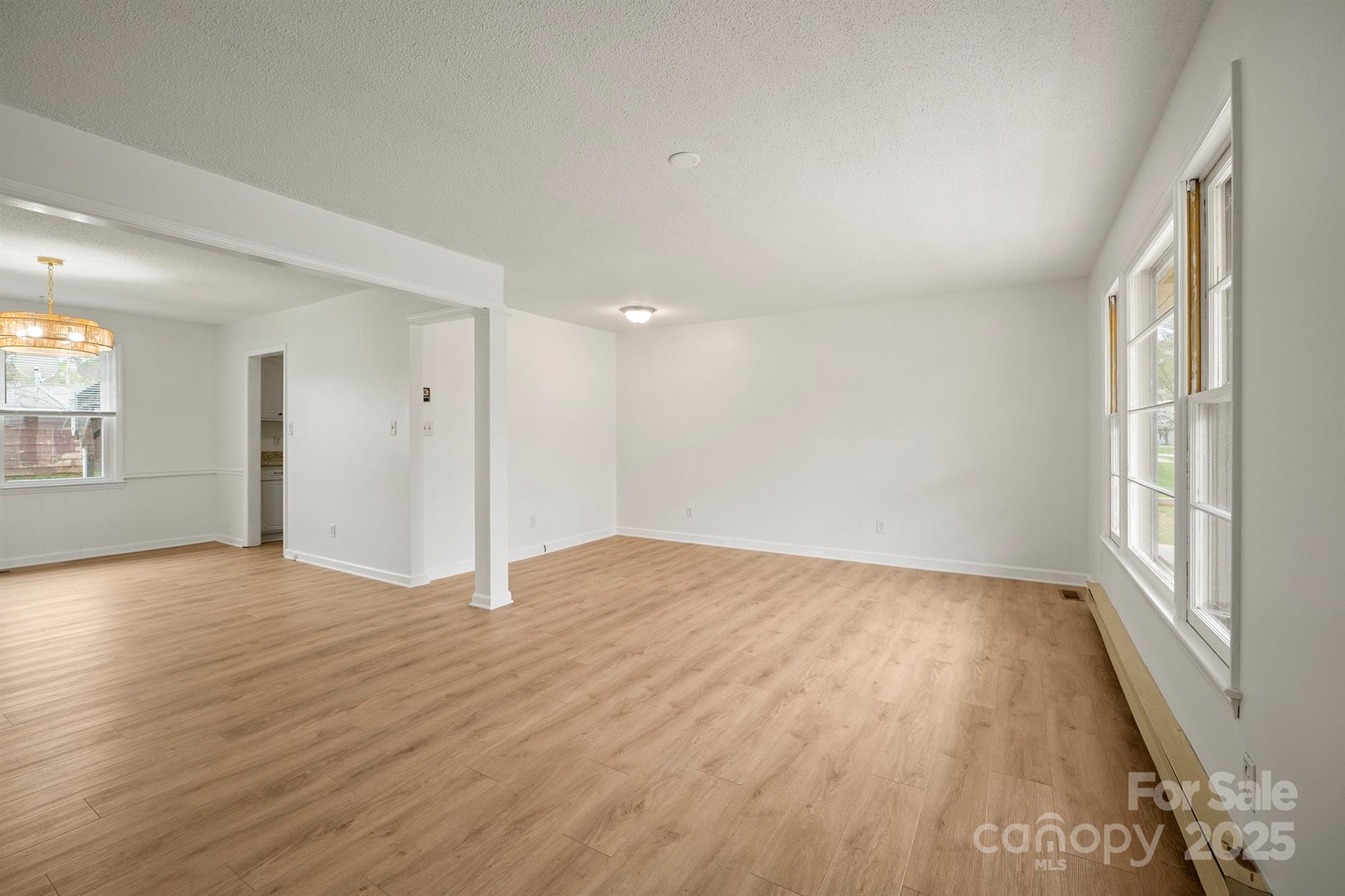303 Windy Rush Road Kannapolis, NC 28081 - Photo 8 of 30 wooden floor in an empty room with a window
