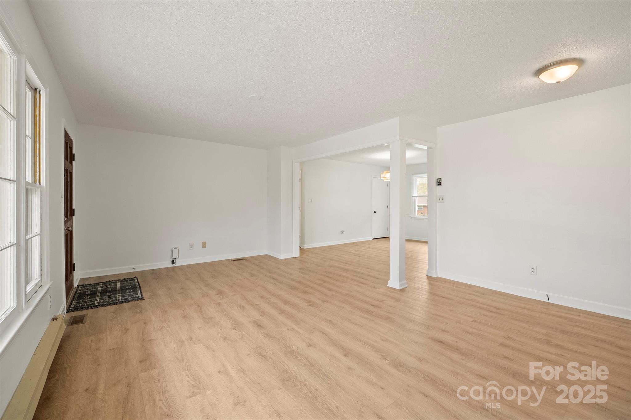 303 Windy Rush Road Kannapolis, NC 28081 - Photo 9 of 30 a view of a room with wooden floor and window
