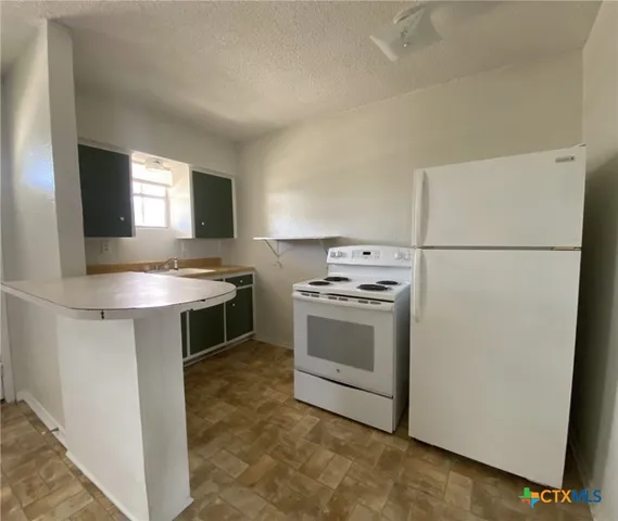 a kitchen with stainless steel appliances a stove a microwave and a refrigerator