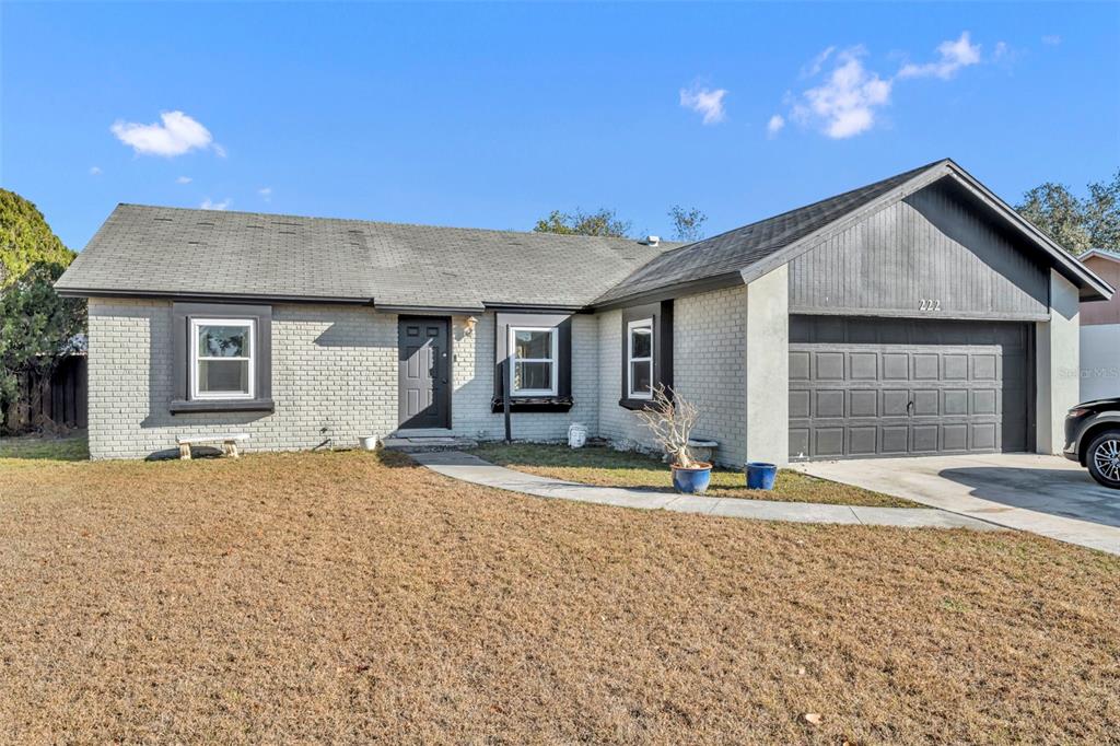 222 West Panama Road Winter Springs, FL 32708 - Photo 1 of 25 a front view of a house with a yard and garage