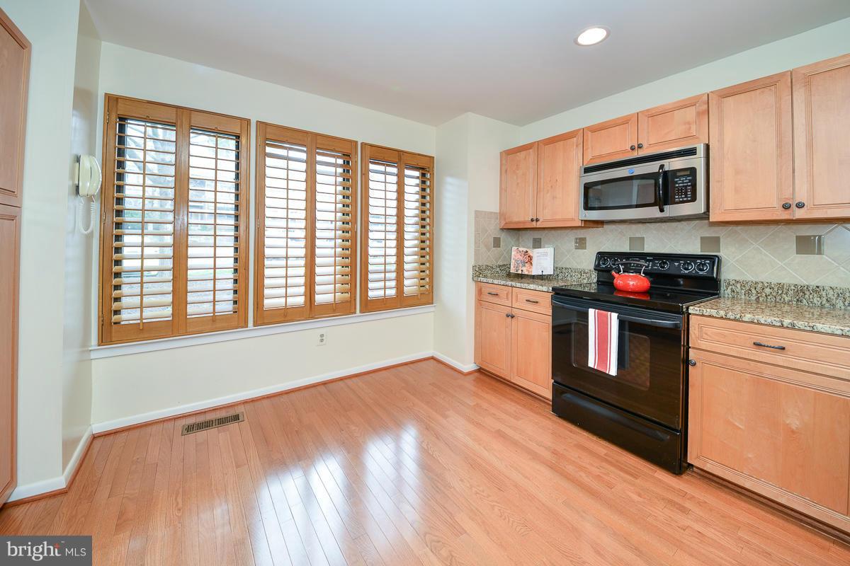 11002 Thrush Ridge Road Reston, VA 20191 - Photo 9 of 29 a kitchen with stainless steel appliances granite countertop a stove and a microwave