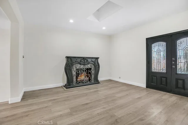 a kitchen with granite countertop a refrigerator stove top oven and sink
