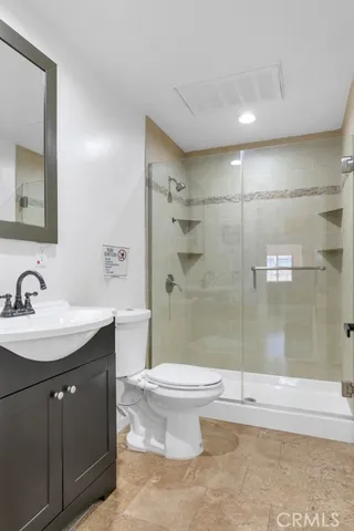 a view of a livingroom with wooden floor and a flat screen tv