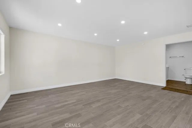 a view of a kitchen with a refrigerator and a sink