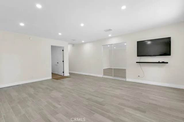 a bathroom with a granite countertop sink a mirror and a shower