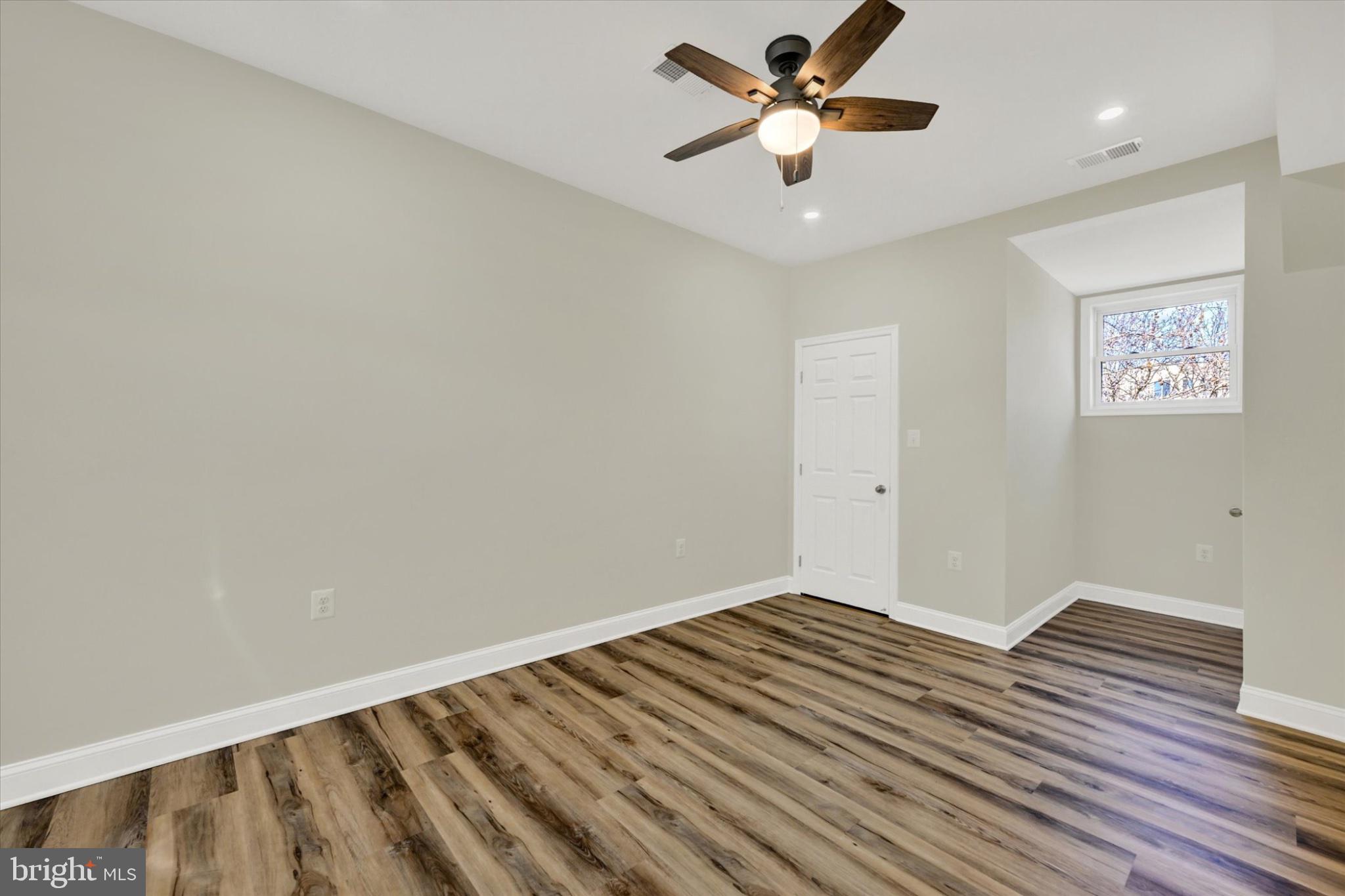 119 North Poppleton Street Baltimore, MD 21201 - Photo 11 of 41 a view of a big room with wooden floor and a ceiling fan