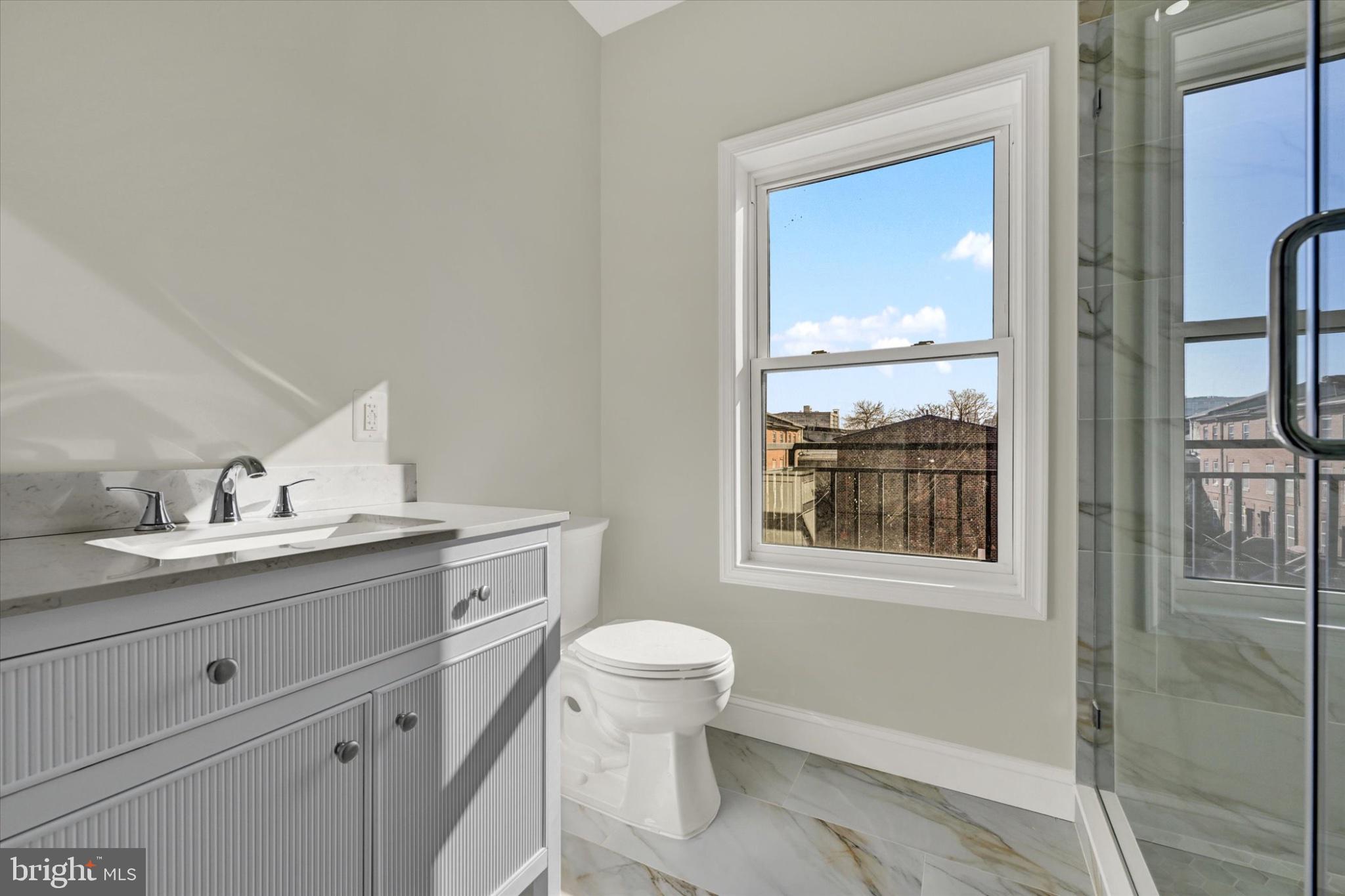 119 North Poppleton Street Baltimore, MD 21201 - Photo 14 of 41 a bathroom with a granite countertop sink toilet and shower