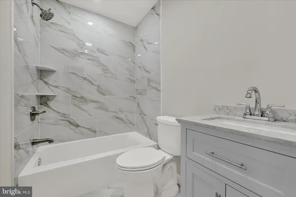 a bathroom with a sink a toilet and a bathtub