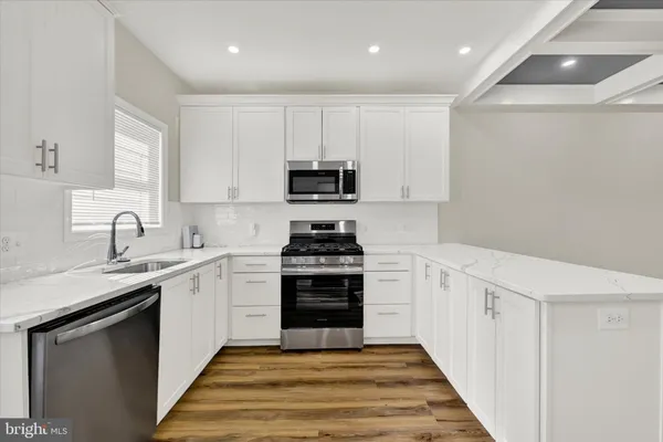 a kitchen with a sink stove and cabinets
