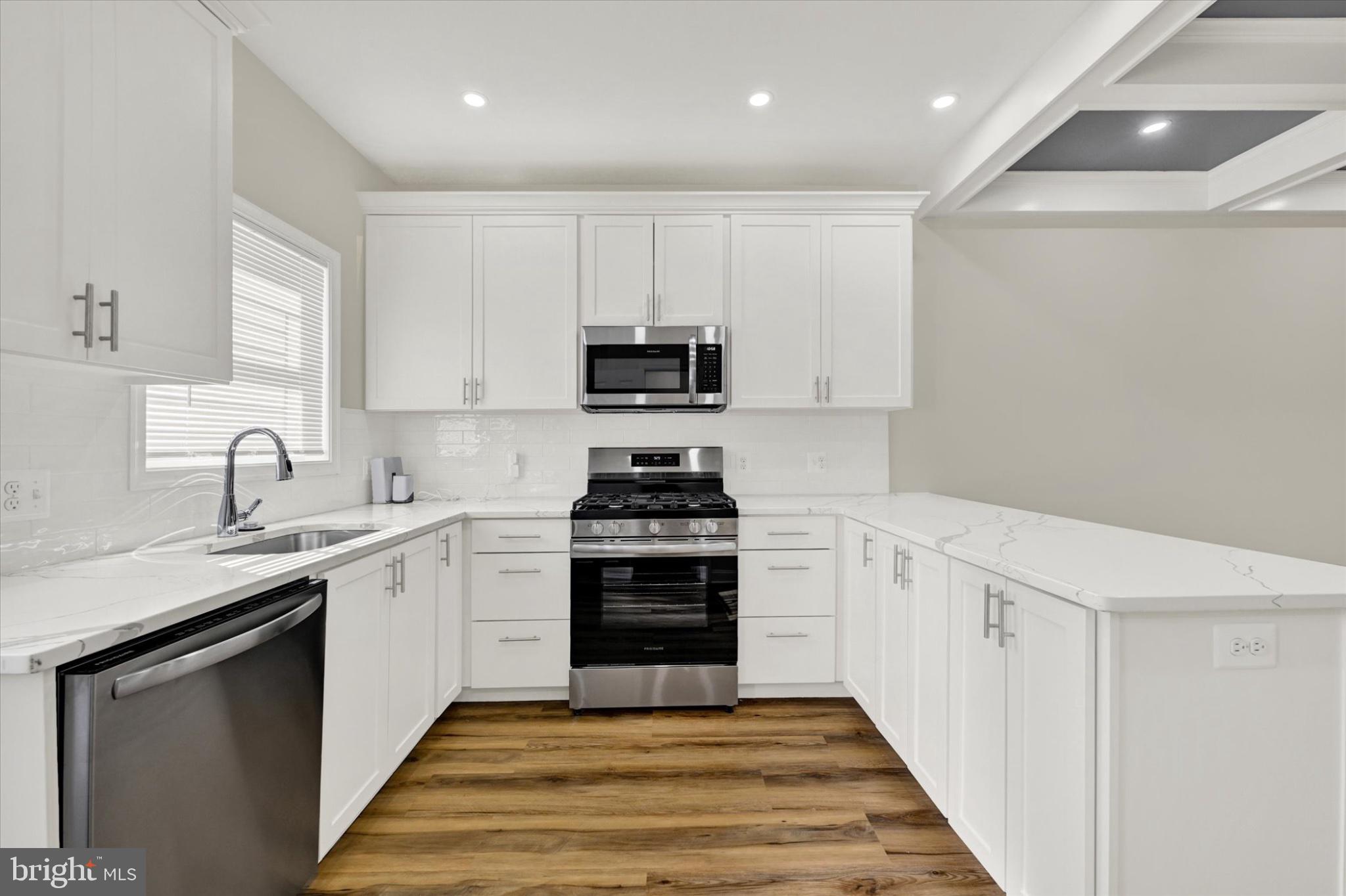119 North Poppleton Street Baltimore, MD 21201 - Photo 19 of 41 a kitchen with a sink stove and cabinets