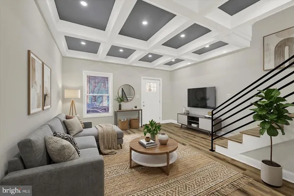 a living room with furniture and a potted plant