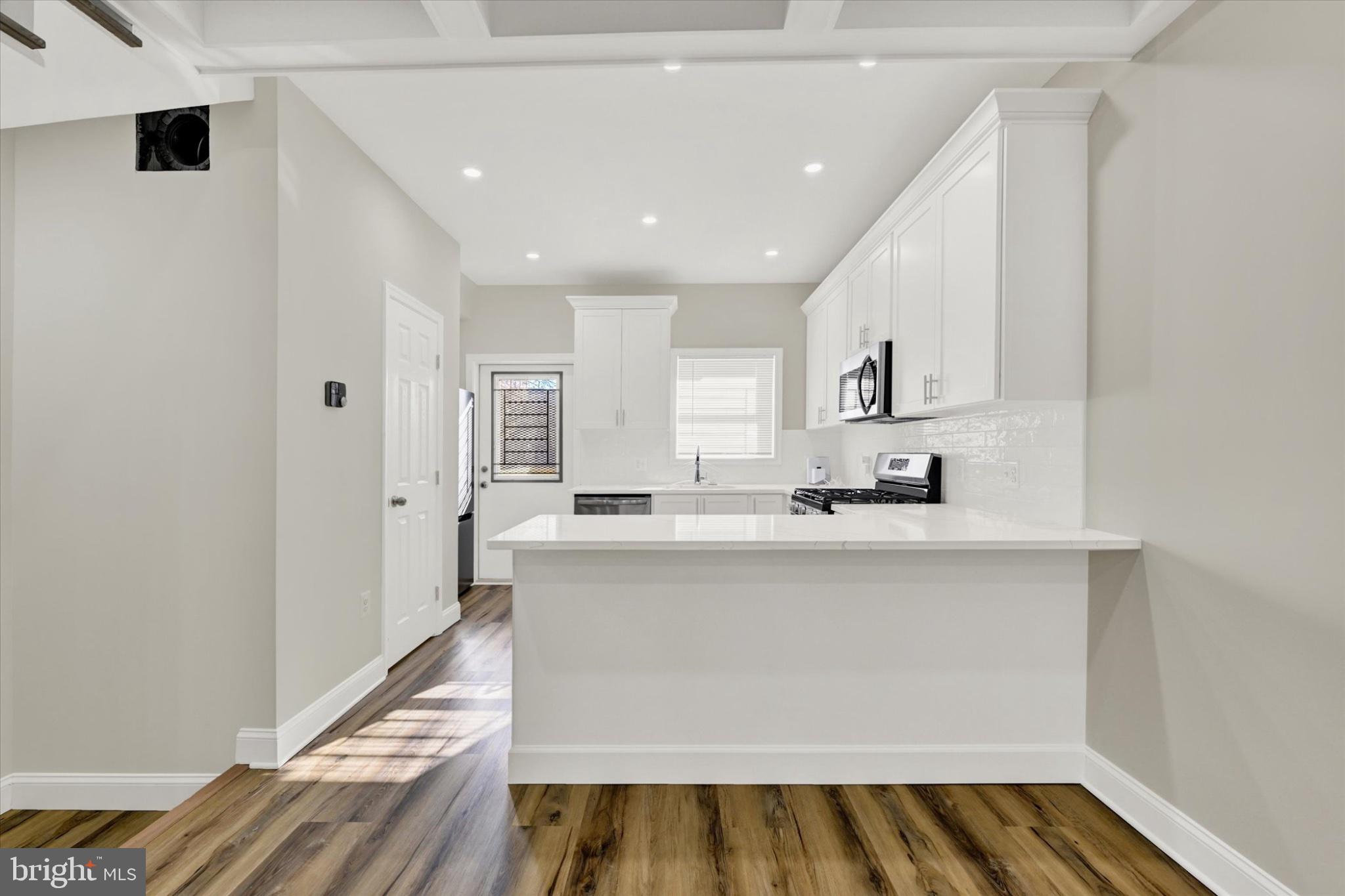 119 North Poppleton Street Baltimore, MD 21201 - Photo 23 of 41 a view of kitchen with microwave and wooden floor