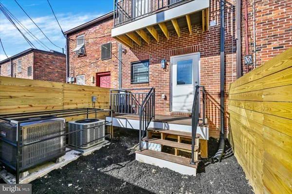a view of a balcony with furniture and a deck
