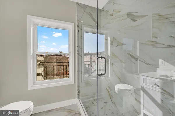 a bathroom with a toilet sink and shower