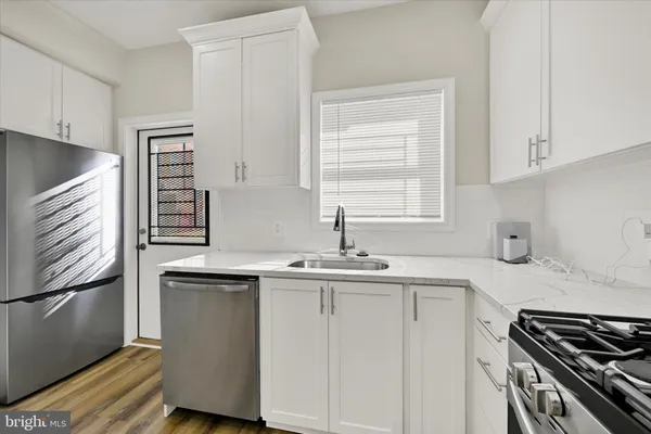 a kitchen with a sink stove and cabinets