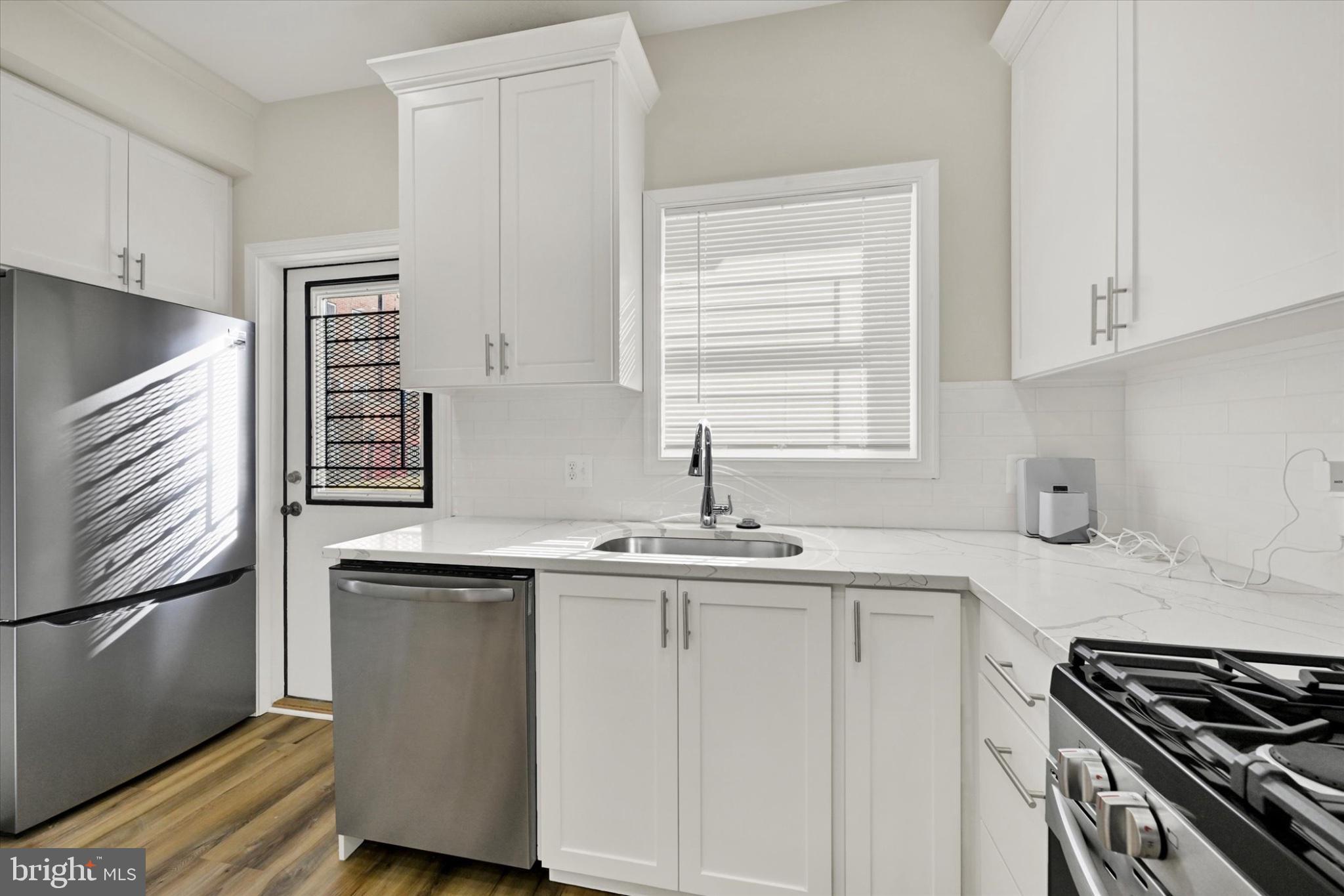 119 North Poppleton Street Baltimore, MD 21201 - Photo 35 of 41 a kitchen with a sink stove and cabinets