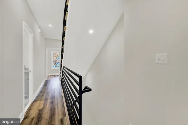 a view of a hallway with stairs