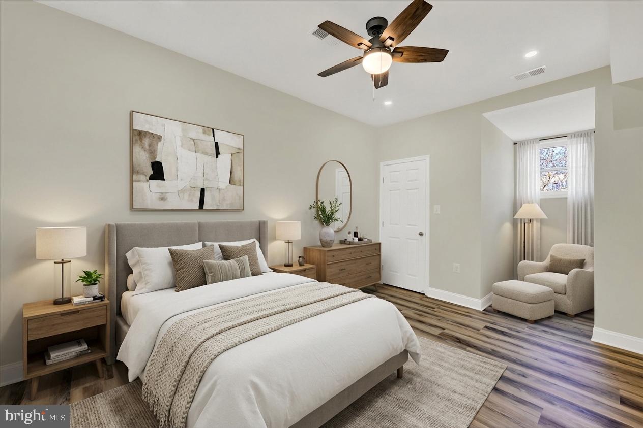 119 North Poppleton Street Baltimore, MD 21201 - Photo 5 of 41 a bedroom with a large bed and a chandelier