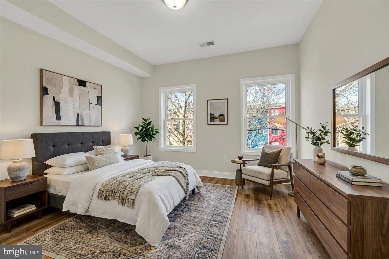 119 North Poppleton Street Baltimore, MD 21201 - Photo 6 of 41 a bedroom with a bed and wooden floor