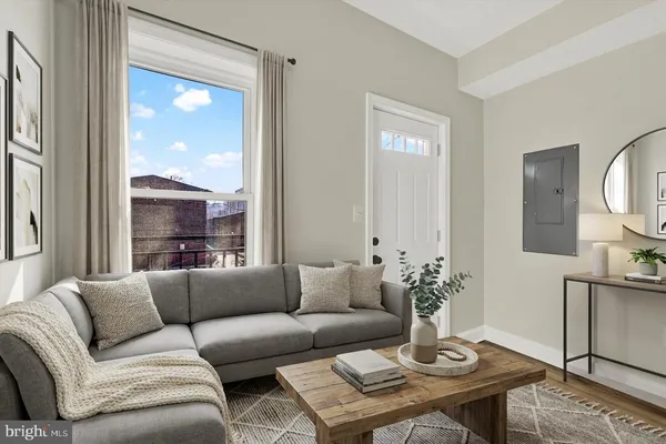 a living room with furniture and a large window