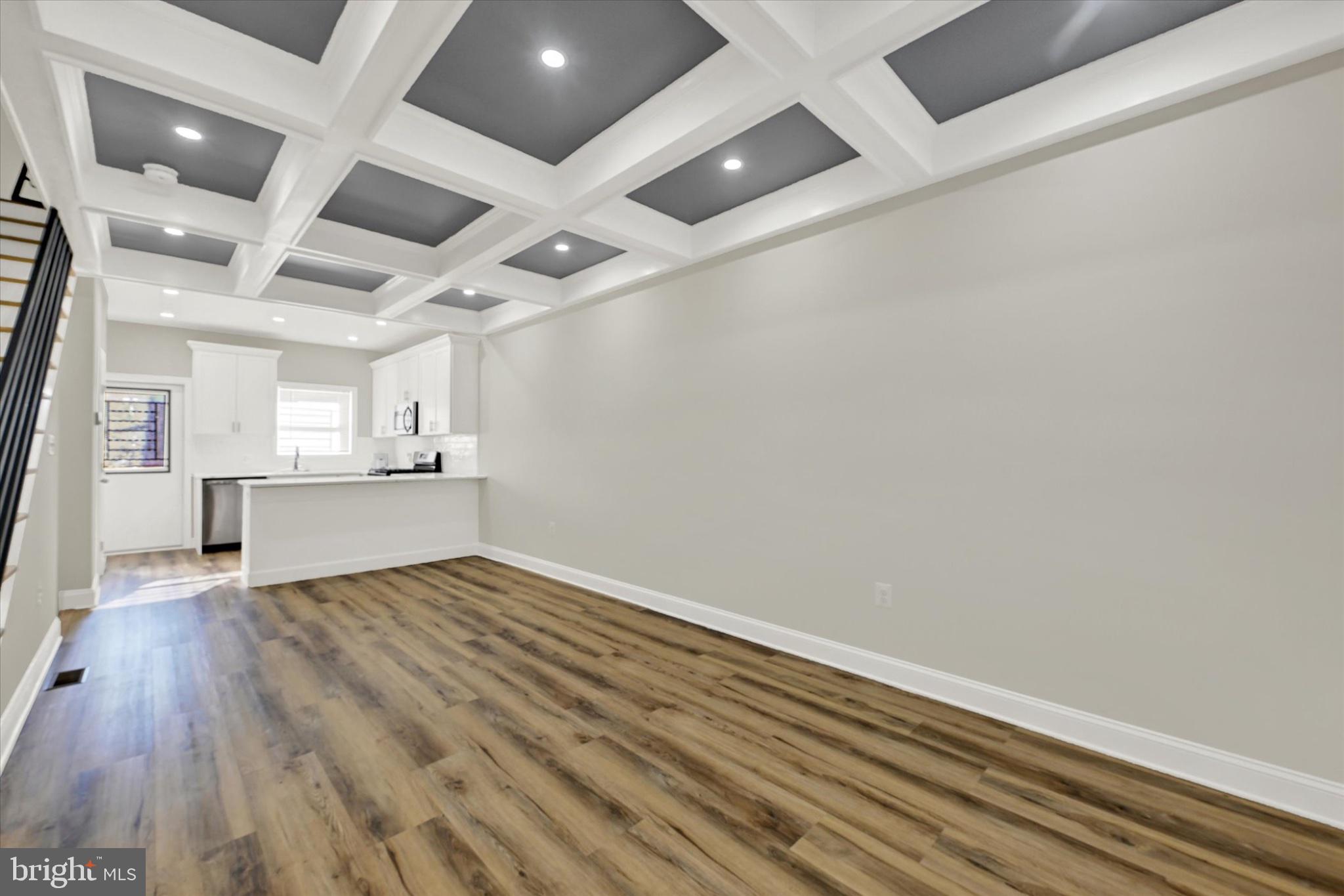 119 North Poppleton Street Baltimore, MD 21201 - Photo 9 of 41 a view of empty room with wooden floor and kitchen view