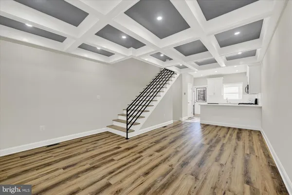 a view of a room with wooden floor