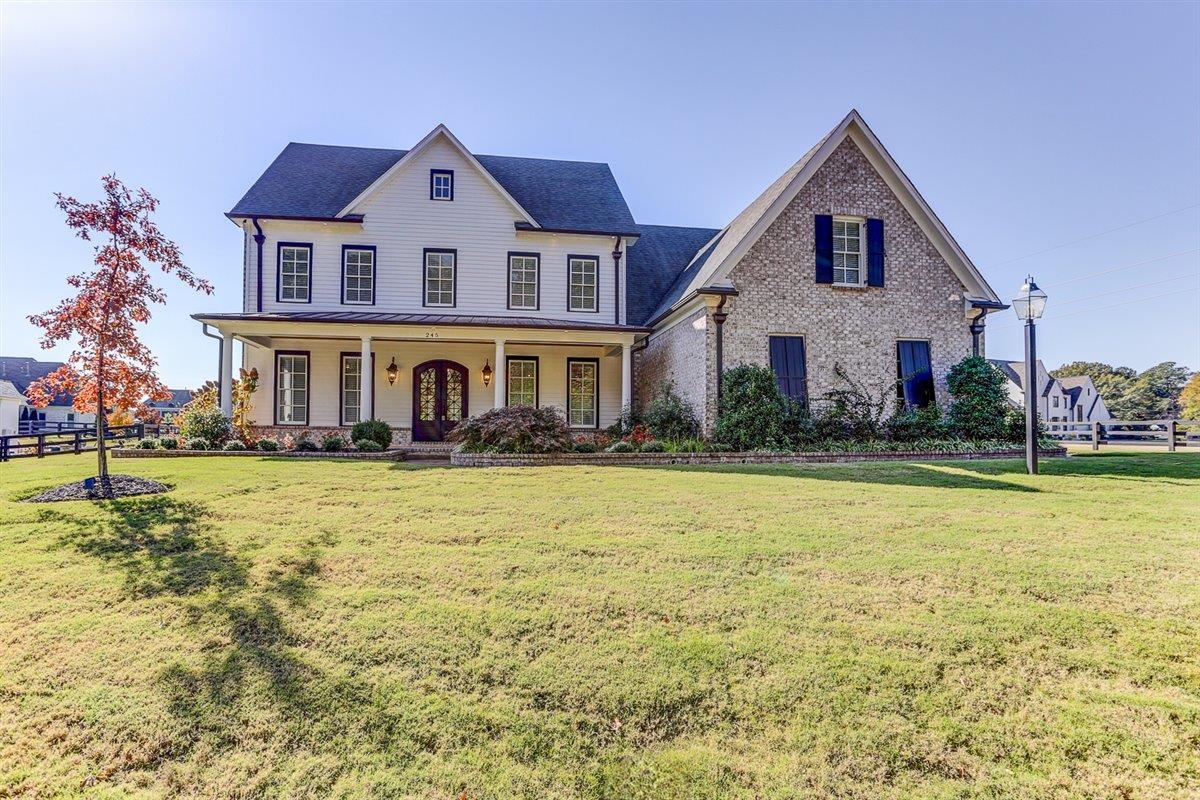 a front view of a house with swimming pool having outdoor seating