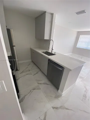 a room with washing machine and sink