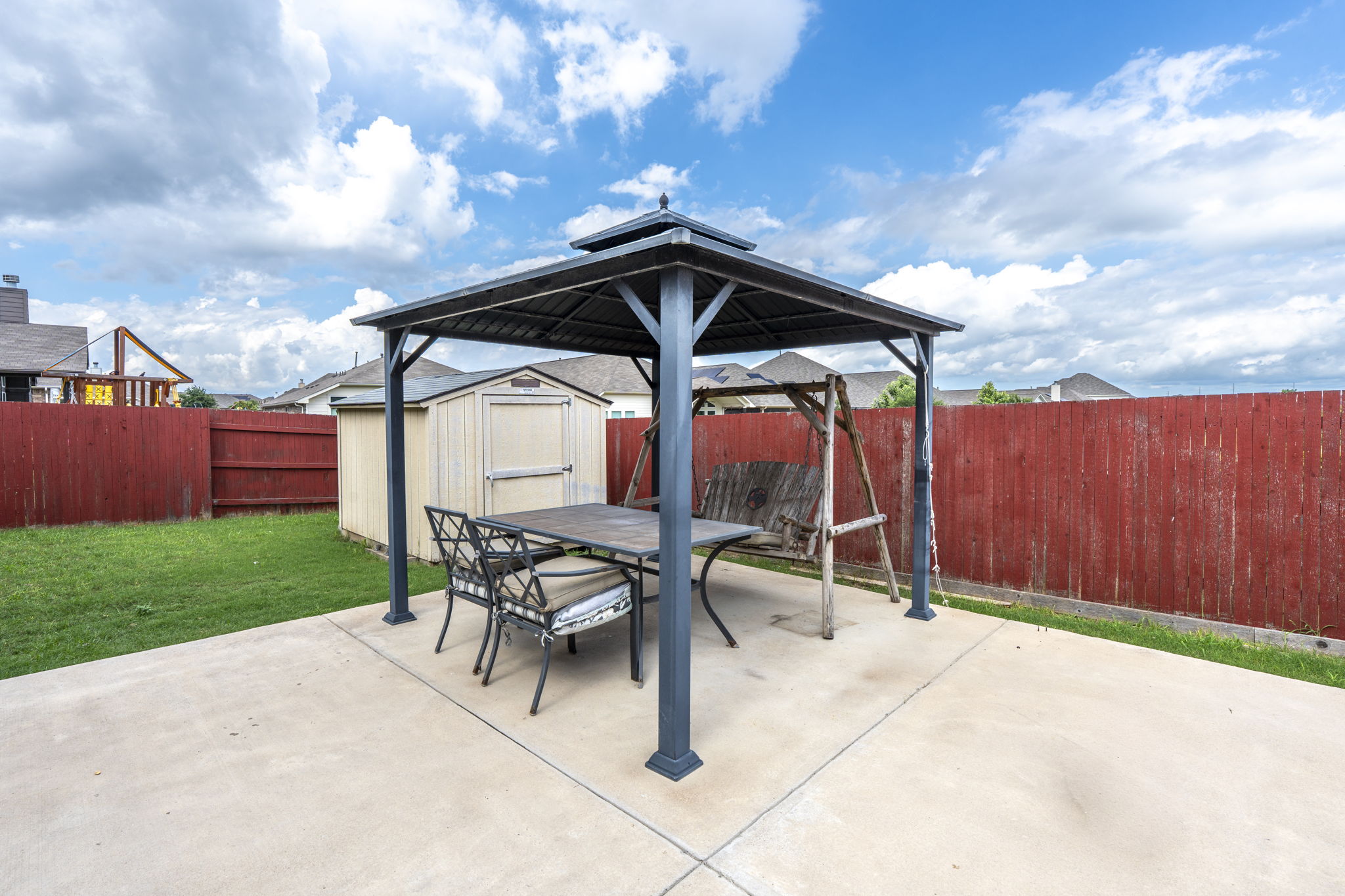 373 Rough Bark Street Buda, TX 78610 - Photo 24 of 39 A well-maintained outdoor patio area, perfect for alfresco dining or enjoying the backyard views.